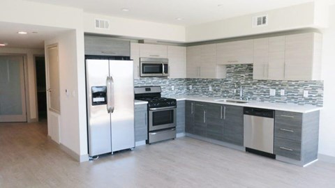 a kitchen with a stainless steel refrigerator and stove