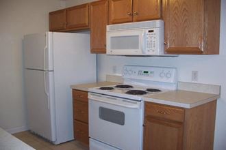 a kitchen with a stove microwave and refrigerator