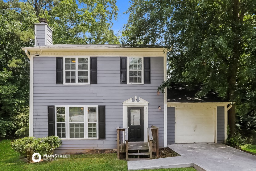 a white house with black shutters and a front door