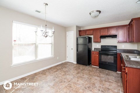 a kitchen with black appliances and wooden cabinets