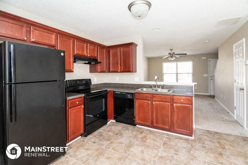 a kitchen with black appliances and wooden cabinets