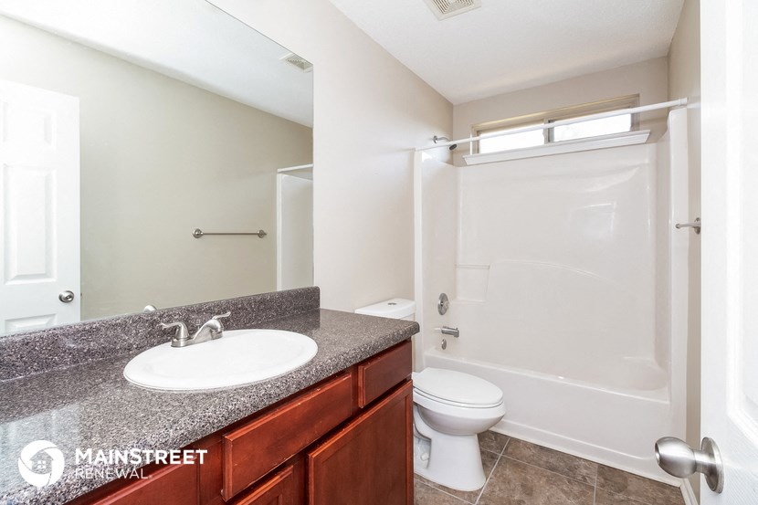 a bathroom with a sink and a shower and a toilet