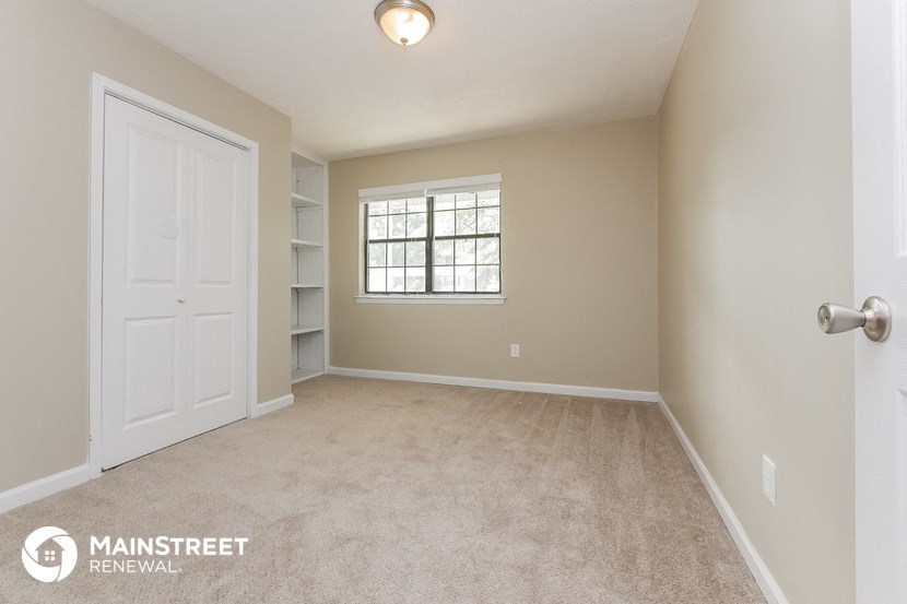 the master bedroom is spacious and has a large closet and a window