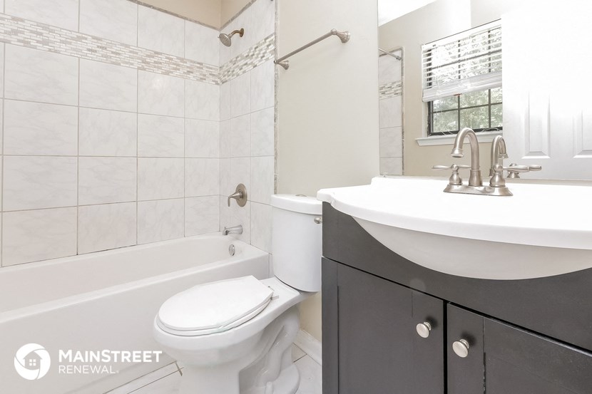 a bathroom with a sink and a toilet and a tub