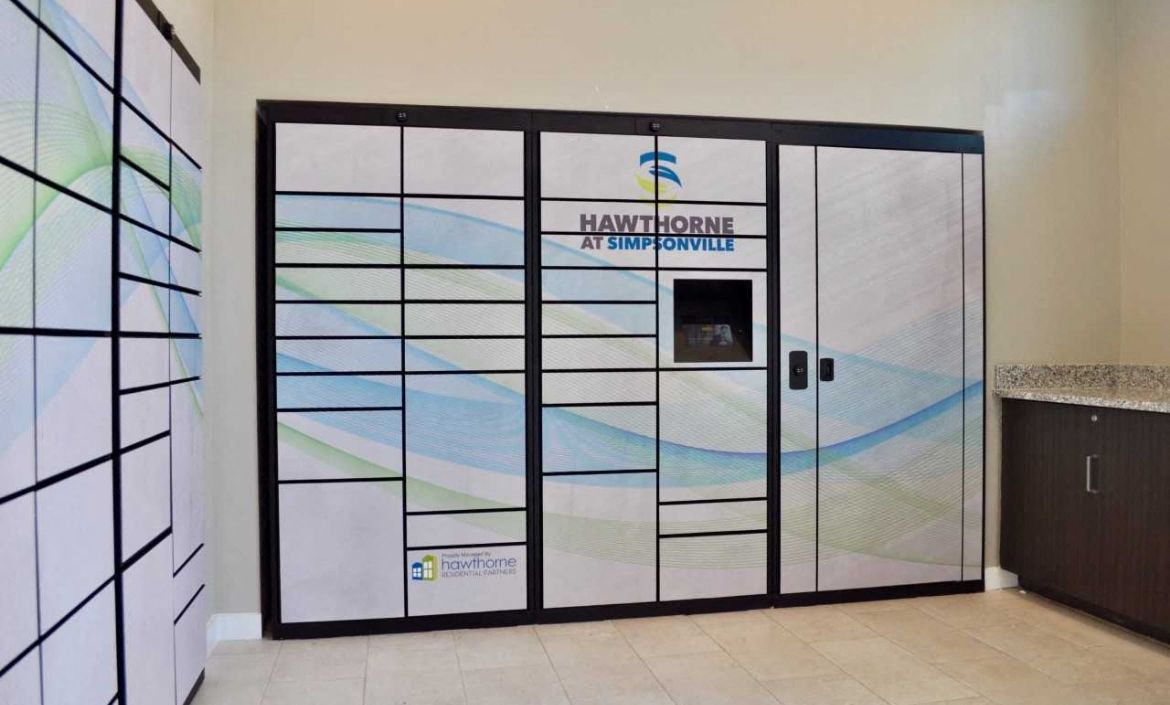 the front door of a hotel lobby with glass doors and a sign