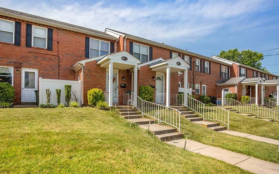a row of brick apartment buildings with stairs