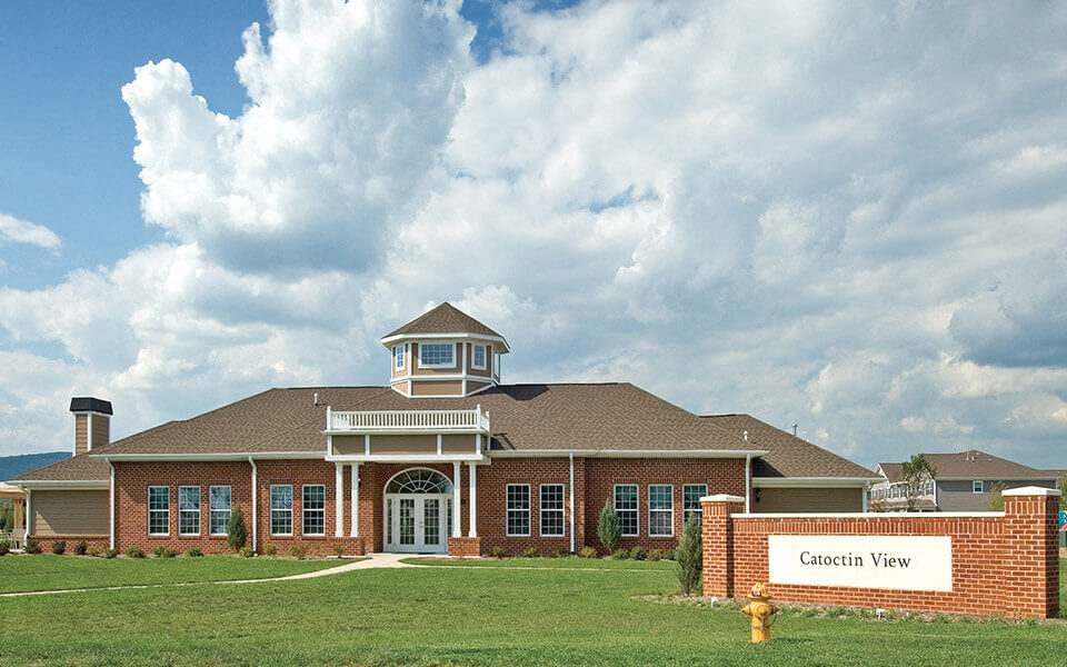 a large brick building with a sign in front of it