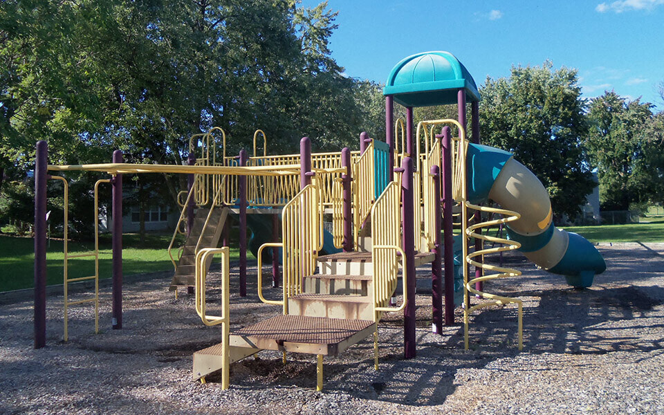 a playground at a park with a slide