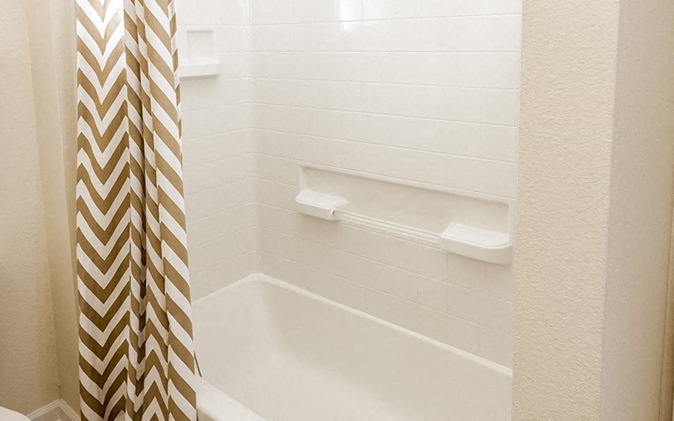 a bathroom with a shower curtain and a tub
