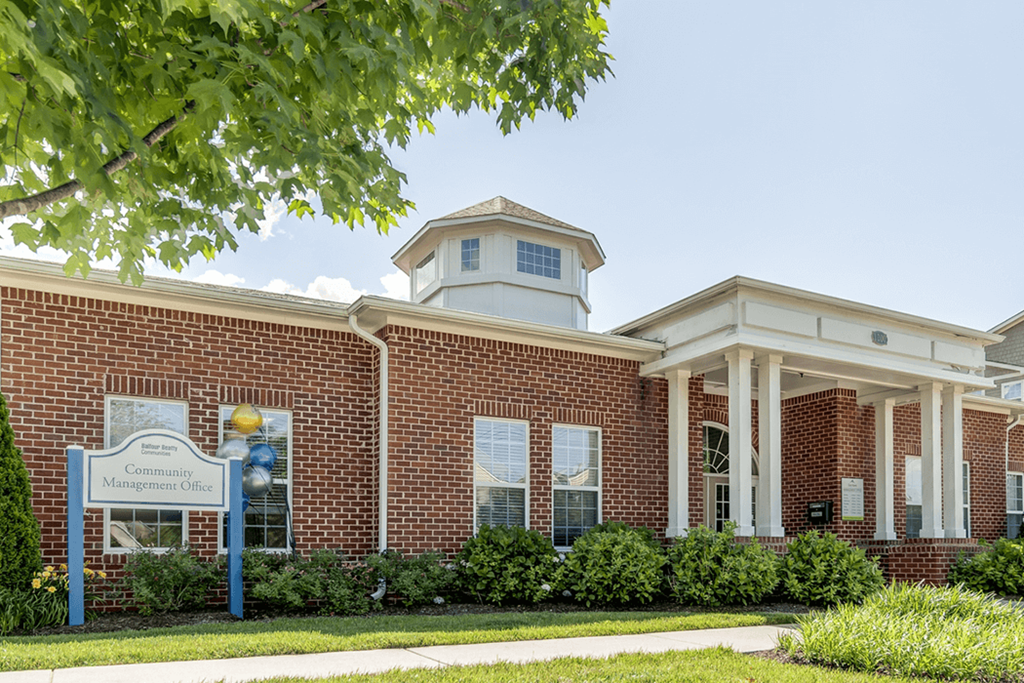 a brick building with a sign in front of it