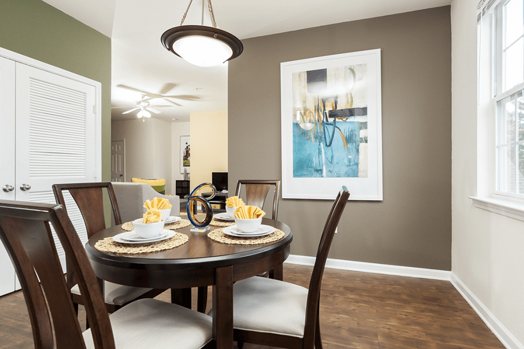 a dining room with a wooden table and chairs