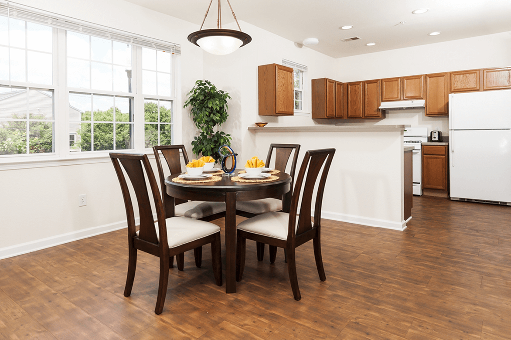 a kitchen and dining room with a table and chairs