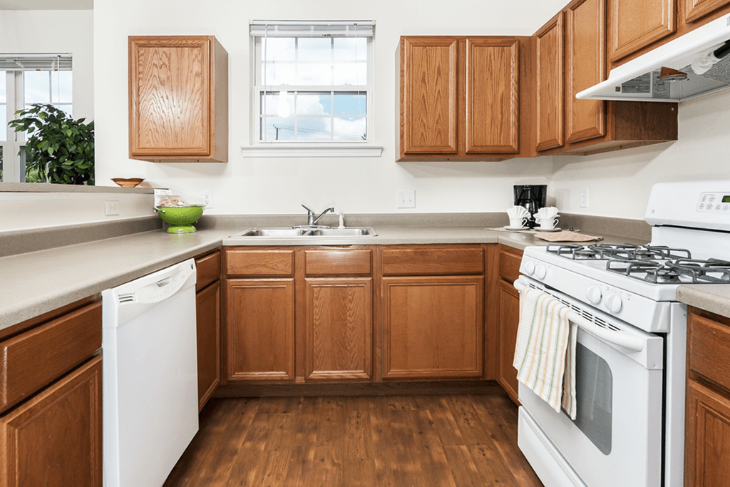 a kitchen with white appliances and wooden cabinets
