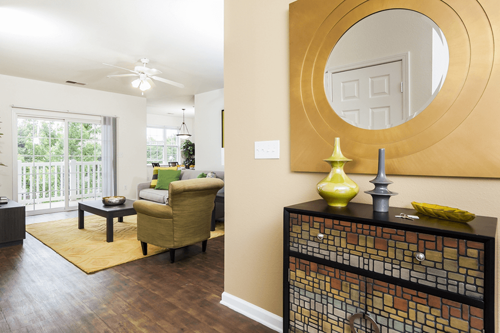 a living room with a round mirror and a couch