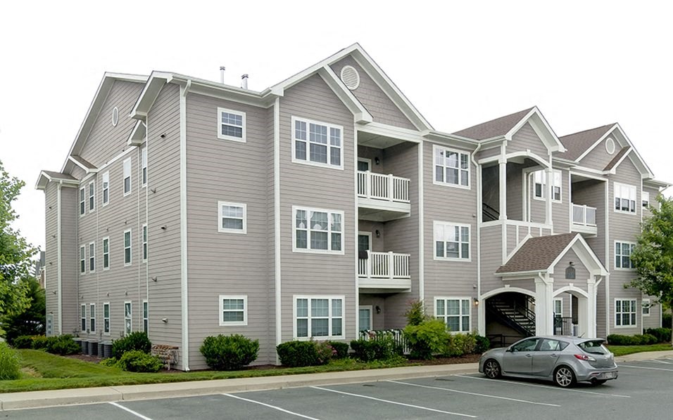 a car parked in front of an apartment building