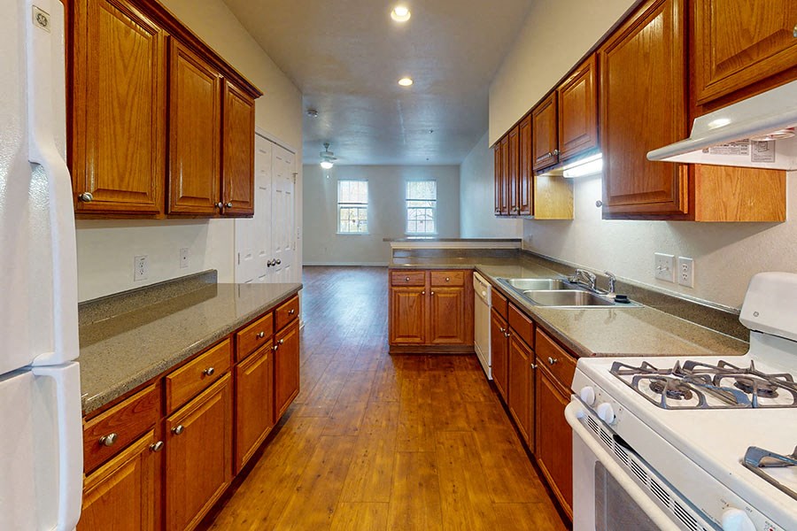 a kitchen with wooden cabinets and a stove top oven