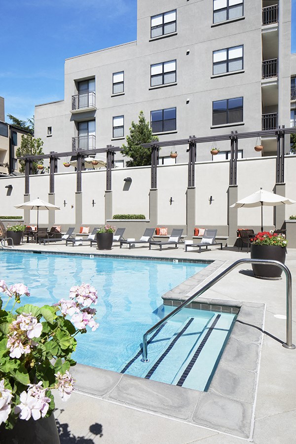 Pool with lounge chairs 1801 L Apartments
