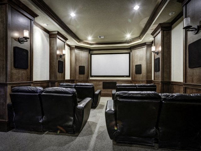 Apartments in Fife, WA - Bella Sonoma - Theatre Room with Projector Screen, Leather Reclining Chairs, and Built-in Speakers