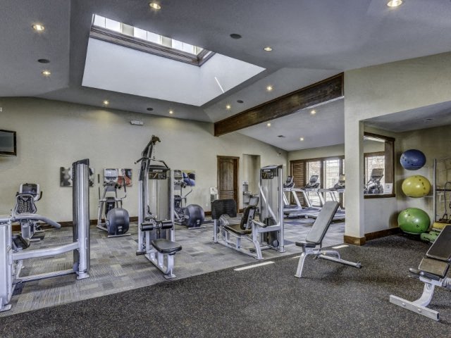 Apartments for Rent in Fife WA - Expansive Fitness Center Featuring Various Gym Equipment and Stylish Interior