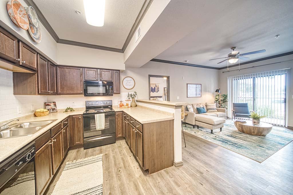 A kitchen with wooden cabinets and a stove top oven.