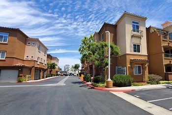 Entry to community with view of buildings and trees - Photo Gallery 4