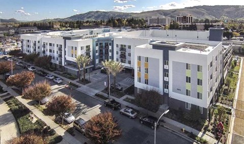 A large white building with a parking lot in front of it.