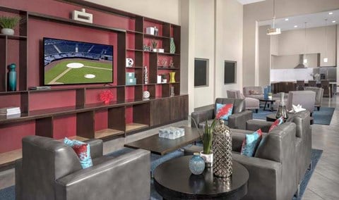 A modern living room with a television displaying a baseball game.