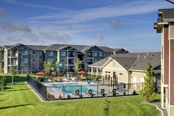 Pool with lounge chairs and apt buildings Copper Steppe Apts for rent in Parker CO - Photo Gallery 5