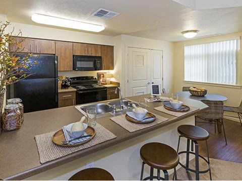a kitchen with a long counter with plates on it