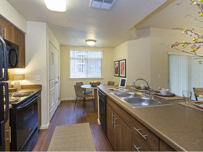 Full kitchen with dining area view Parker CO Apartment Rentals at Copper Steepe 