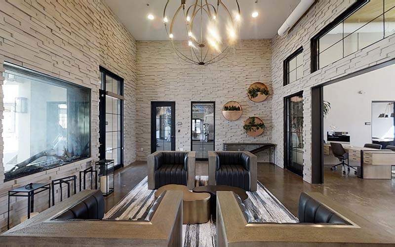 Clubhouse with seating by fireplace  l Azure Apartments in Sparks NV