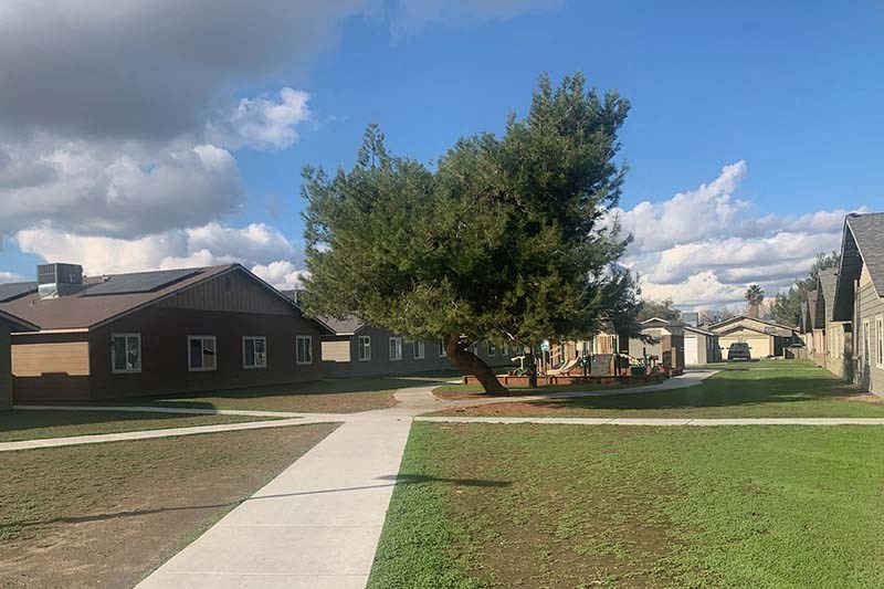 Exterior view of buildings with grass and sidewalks with grass and sidewalks