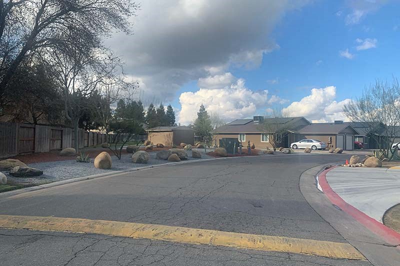Entry to community with view of building from street