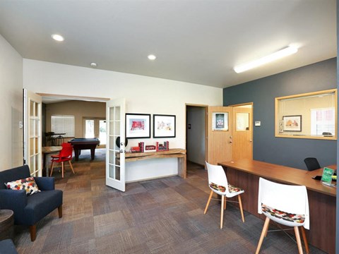 a living room and dining room with a table and chairs