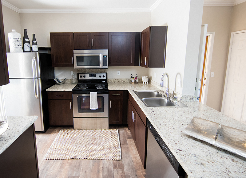 A kitchen with a stove top oven and a microwave.