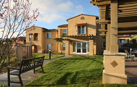 Bench near grass and buildings l Mirandela Apartments in Rancho Palos Verdes