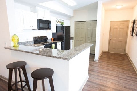 Fitted Kitchen With Island Dining at Monroe Place Apartments, Atlanta, GA, 30324