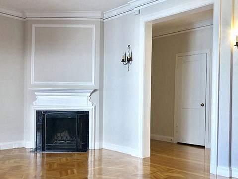 a living room with a fireplace and a wooden floor