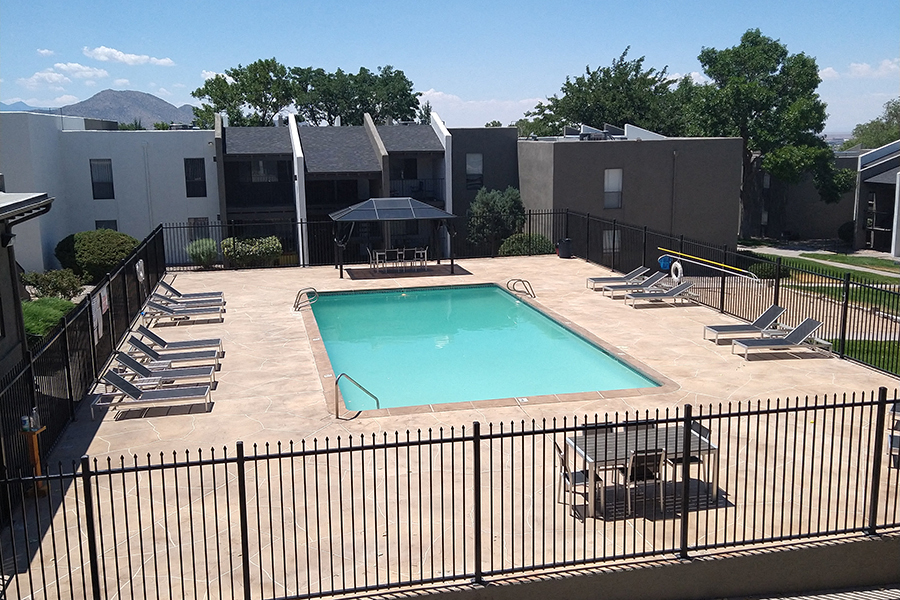 A black fence surrounds a small pool.