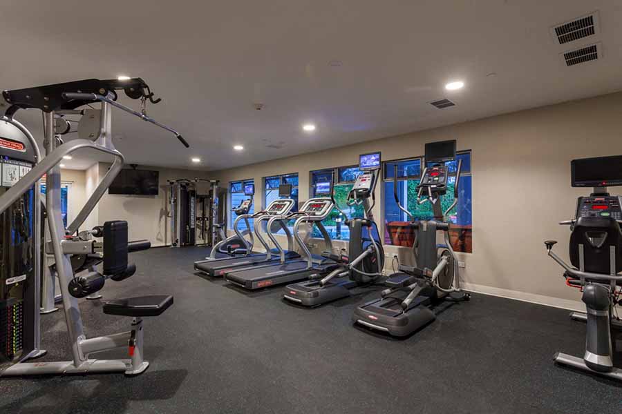 Apartments for Rent in Campbell - Parc at Pruneyard - Resident Fitness Center With a Variety of Handweights, a Mirror Wall, and Various Exercise Machines