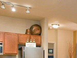 Dining table, living room and kitchen The Retreat at CTM Apartments For Rent l Waco Texas