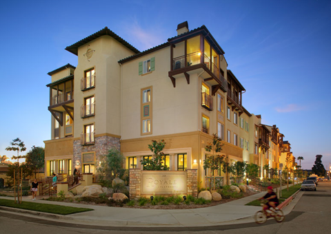 a person riding a bike in front of a building