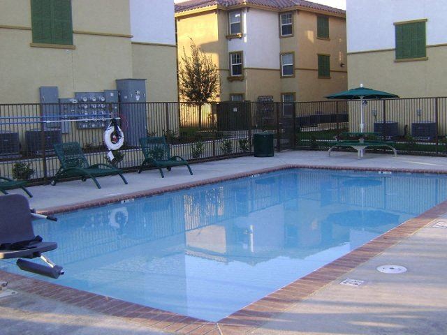 Pool with seating l Santa Fe Apartments in Bakersfield CA