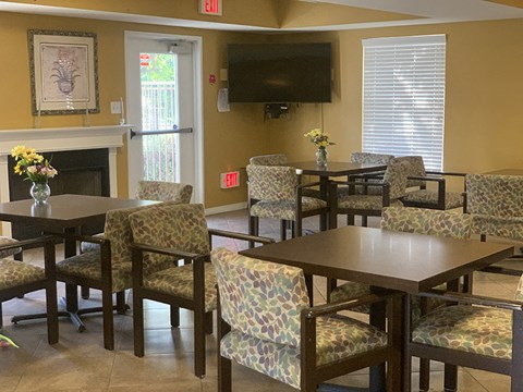 a dining room with tables and chairs and a television