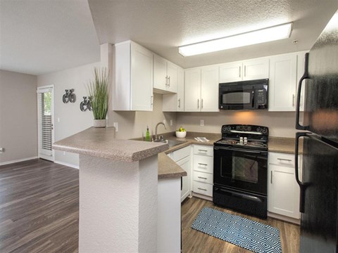 a kitchen with white cabinets and a counter top