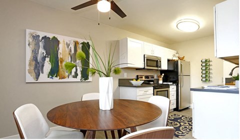 a kitchen and dining room with a wooden table