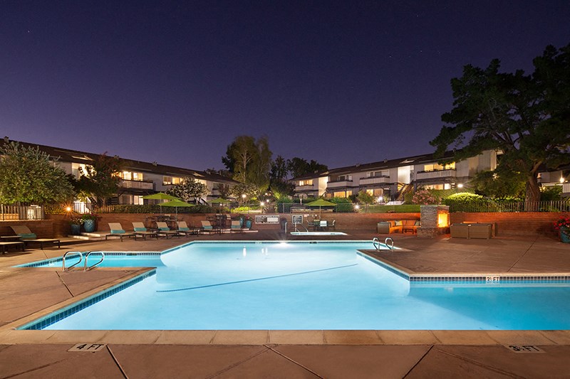 Apartments for Rent in Walnut Creek, CA - Stoneridge - Pool with Lounge Seating, Umbrellas, a Jacuzzi, and a Fireplace