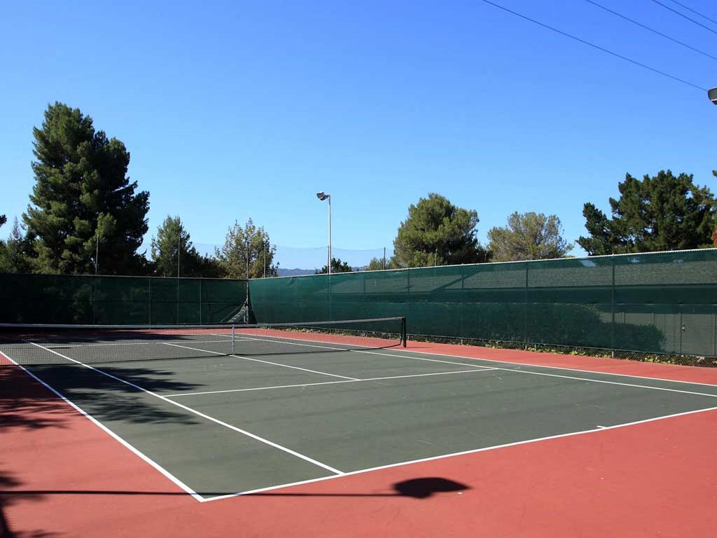 Walnut Creek, CA Apartments - Stoneridge - Tennis Court with a Net, a Fence, Outside Lighting, and Beautiful Scenery