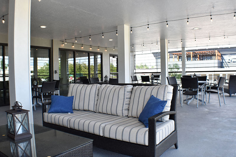 a living room with a couch and tables and chairs