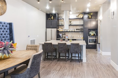 A modern kitchen with a dining table and chairs.